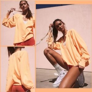 NWOT FP Movement Reflect Layer Long Sleeve Top in neon Clementine Orange
